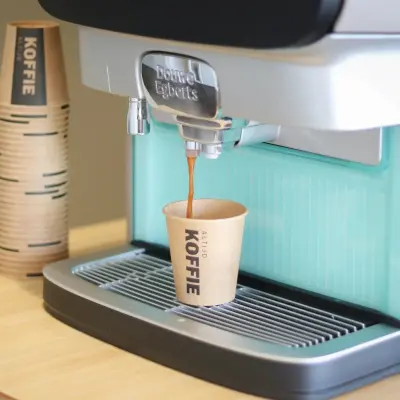 Coffee machine on a wooden counter in an office space, located in Apeldoorn at Prins Willem-Alexanderlaan 401.