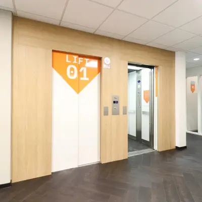 Interior view of an elevator lobby at Prins Willem-Alexanderlaan 401, Apeldoorn, suitable for office space rental, showcasing a clean and modern design.
