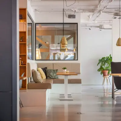 Bright and modern furnished office space on Roggestraat 111, featuring cozy seating areas and stylish decor, perfect for office space rental.