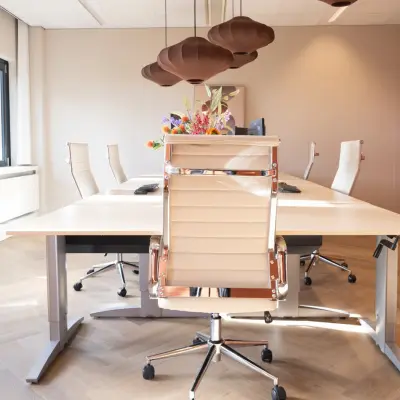 Modern furnished office space rental at Schumanpark 9, Apeldoorn with conference table and ergonomic chairs ready for business meetings.