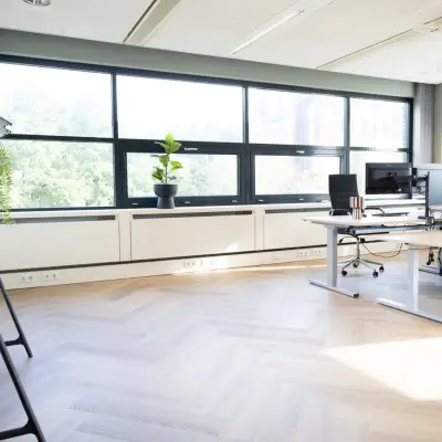 Bright office space in Schumanpark 9, Apeldoorn, featuring modern desks and large windows, perfect for those seeking office space rental.