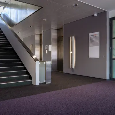 Interior view of the office entrance at Amalialaan 126, Baarn with stairs and elevator access, ideal for office space rental.