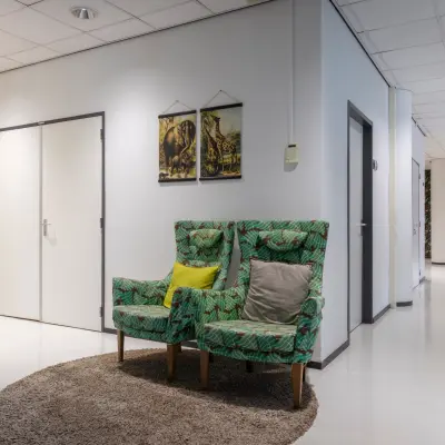 Furnished office interior at Amalialaan 126, Baarn, displaying cozy chairs in a hallway, ideal for rent office space seekers. Subtle decor enhances the atmosphere for office space rental.