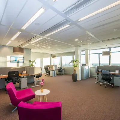 Spacious and bright office at Carrer de la Marina 16-18, Barcelona Sant Martí with several workstations, modern furnishings, and large windows offering city views, ideal for office space rental.