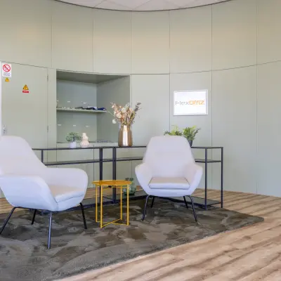 Modern office reception area with two armchairs, a table, and decorative elements at Kamerlingh Onnesweg 10, Barendrecht, ideal for office space rental.