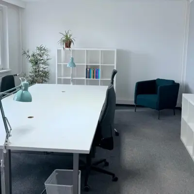 Bright office space in Berlin Friedrichshain with white desks, chairs, and shelves, ideal for office space rental.