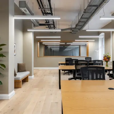 Interior view of a furnished office to rent at Chausseestraße 29, Berlin Kreuzberg, featuring modern desks and chairs arranged in a spacious layout.