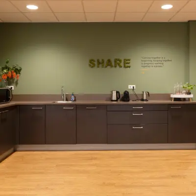Modern office pantry at Marktstraat 1-7, Bodegraven, ideal for office space rental with sleek cabinets and appliances.