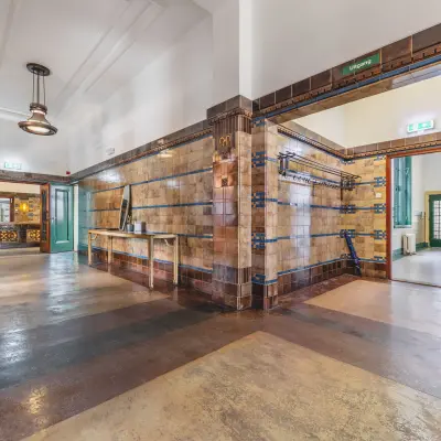 Interior view of an office space at Ceresstraat 13, Breda Centrum-Station, showcasing a tiled hallway with visible doors leading to different rooms, offering potential for office space rental.