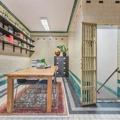 Furnished office space at Ceresstraat 13 in Breda Centrum-Station with wooden desk, shelves, and decorative items. An ideal spot for office space rental with a vintage look.