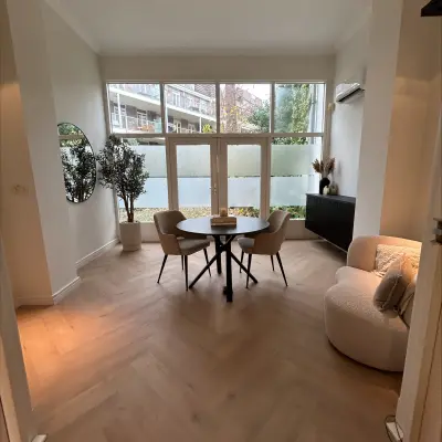 Cozy office space at Sophiastraat 40 40, Breda Centrum-Station, featuring a furnished area with a round table, chairs, and a plush armchair, ideal for office space rental.