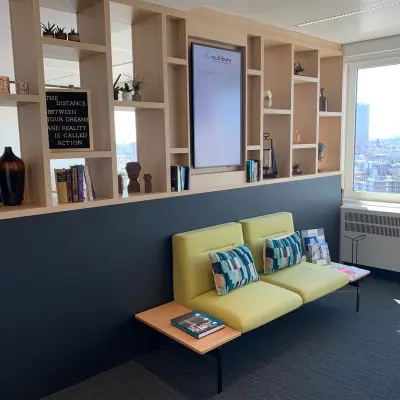 A well-lit office space at Rue Joseph Stevens 7 in Brussels Center, featuring modern seating and decorative shelves, ideal for an inviting office to rent experience.