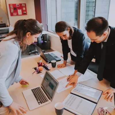 Professionals collaborating in an office space at Rue Joseph Stevens 7, Brussels Center, ideal for office space rental.