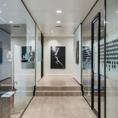 Modern office space at Rue des Colonies 56, Brussels European District featuring glass-walled workspaces and contemporary art, ideal for rent office space seekers.
