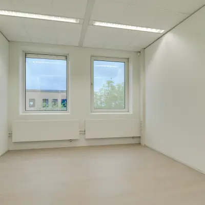 Unfurnished office space with large windows at Regulierenring 2, Bunnik, ideal for office space rental.