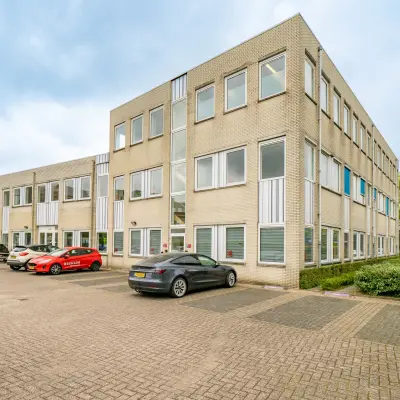 Exterior view of office building at Regulierenring 2, Bunnik with parking area for office space rental.