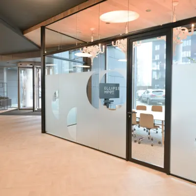 Modern conference room available for office space rental at Rivium Quadrant 75, Capelle aan den IJssel, featuring large glass doors and stylish lighting.