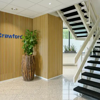 Modern office entrance at Vlierbaan 20, Capelle aan den IJssel, with a staircase and decorative plants, available for office space rental.