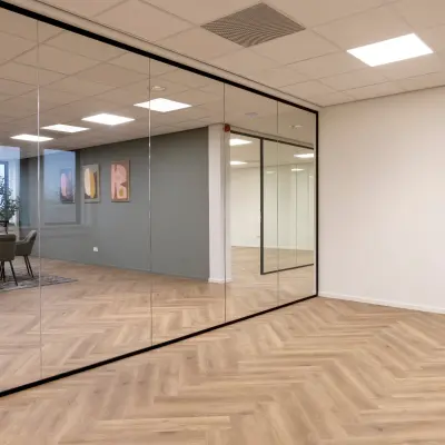 Modern office to rent at Vlierbaan 20, Capelle aan den IJssel, featuring glass walls and wooden flooring, ideal for office space rental.