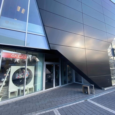 Modern exterior view of an office space available for rent at Marcika 27, Cracow Łagiewniki Borek Fałęcki, featuring sleek architecture and large windows.