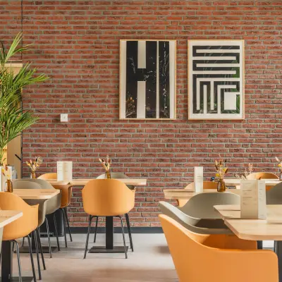 Furnished workspace at Rijnzathe 12 in De Meern featuring modern seating and tables, ideal for office space rental.