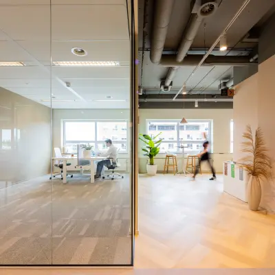 Modern office space at Rijnzathe 12, De Meern, featuring furnished workspaces with people collaborating, ideal for office space rental.