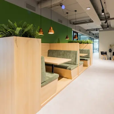 Stylish office interior at Rijnzathe 12, De Meern, featuring furnished booths and greenery for rent office space.