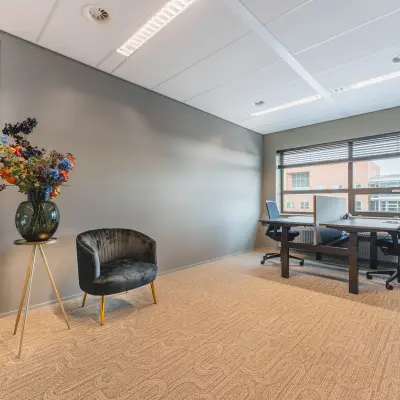 Bright office space with modern furniture and large windows at Rijnzathe 12, ideal for rent office space needs.