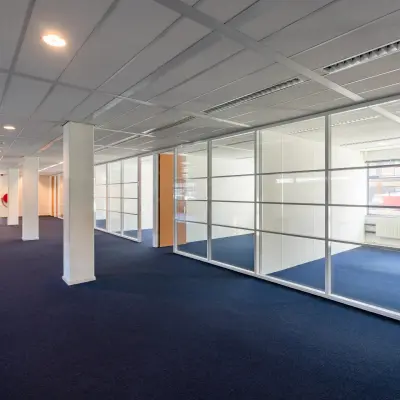 Spacious and bright office space for rent at Delftechpark 17-19 in Delft, featuring large windows and several partitioned areas ideal for office space rental.