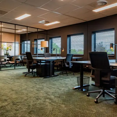 Furnished office space for rent at Reitschweg 1, Den Bosch, featuring desks, chairs, and ample natural light.