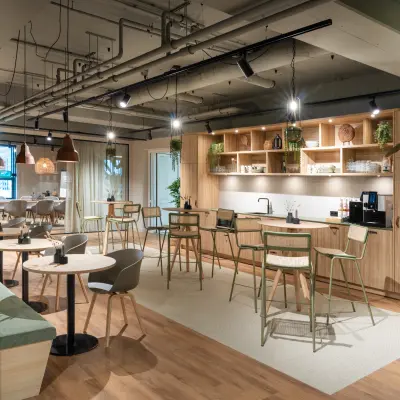 Spacious office space rental at Diemerhof 42, Diemen, featuring a modern kitchen and seating area ideal for collaboration or individual work.