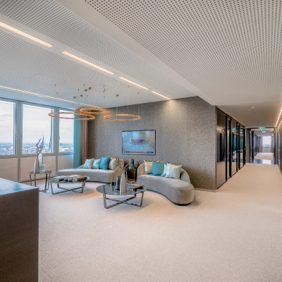 Bright, furnished office space with a seating area and large windows offering city views in Düsseldorf Old Town, perfect for office space rental.
