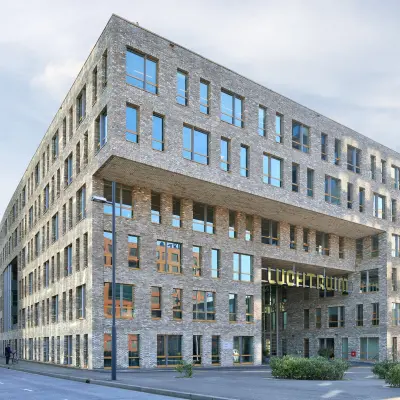 Modern office building exterior at Flight Forum 120-159, Eindhoven Airport, showcasing contemporary architecture with large windows. Perfect location for office space rental.