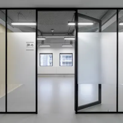 A modern office space rental in Eindhoven Center with frosted glass partitions and large windows offering natural light, suitable for businesses looking to rent office space.