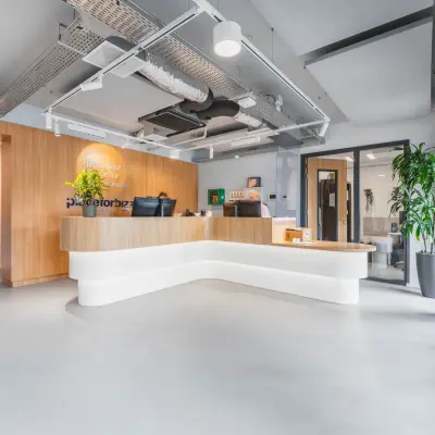 Bright office reception area at Hurksestraat 60, Eindhoven De Hurk, featuring modern design with plants and a stylish desk, ideal for office space rental.