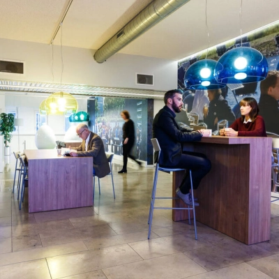 Modern office interior at TU campus, Eindhoven, featuring high tables and engaging workspaces. Ideal for those seeking office space rental in a vibrant, collaborative environment.