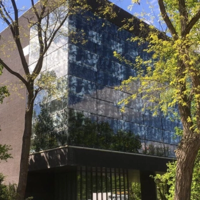 Modern office building at TU campus, De Zaale 11, Eindhoven High Tech Campus, surrounded by lush trees, featuring sleek glass windows. Ideal for office space rental.