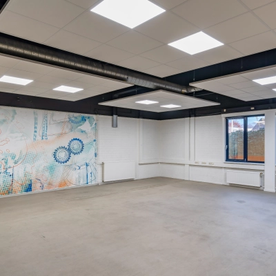 Spacious office interior at Tarasconweg 2, Eindhoven North featuring large windows and decorative wall art, ideal for office space rental.