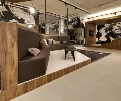 Stylish office space at Frederiklaan 10E, Eindhoven Strijp-S, featuring modern seating and wall art, ideal for office space rental.