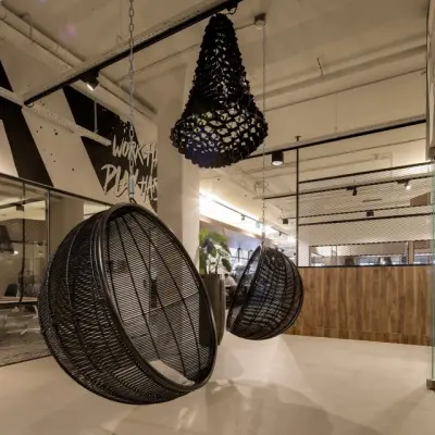 Stylish office space with hanging chairs and modern decor, located at Frederiklaan 10E in Eindhoven Strijp-S, ideal for office space rental.
