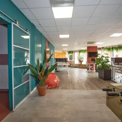 Spacious office to rent at Boddenkampsingel 95, Enschede, featuring modern workspaces with vibrant decor and greenery. Ideal for office space rental.