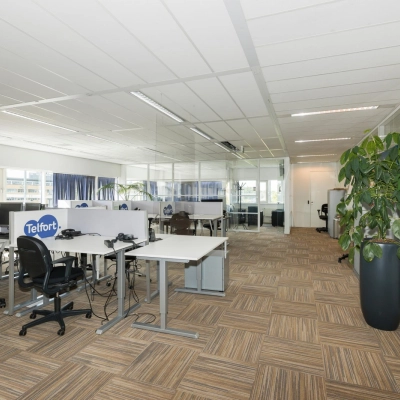 Bright open-plan office space with modular workstations and glass partitions at Brandweerstraat 20-30, Enschede. Ideal for businesses seeking flexible office space rental.