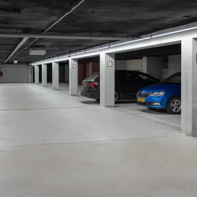 Spacious indoor parking area at Kuipersdijk 2-4 in Enschede, part of an office space rental offering.