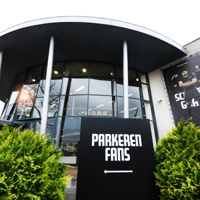 Exterior view of the office space available for rent at Parkweg 102, Enschede, with sleek glass windows and greenery.
