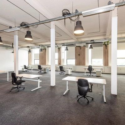 Furnished office space for rent at Rigtersbleek-Zandvoort 10, Enschede, featuring multiple desks and chairs in an open-plan layout.