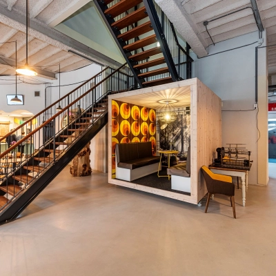 Modern office space at Rigtersbleek-Zandvoort 10, Enschede featuring a stylish meeting area under a staircase, ideal for rent office space options.