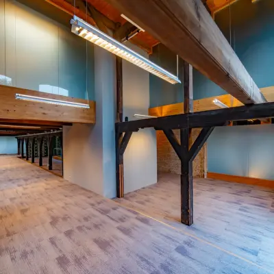 Spacious office for rent at Prins Hendrikkade 3, Franeker, featuring rustic beams and natural lighting, ideal for dynamic office space rental.