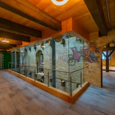 Interior view of office space at Prins Hendrikkade 3, Franeker, featuring exposed brickwork and a modern loft design ideal for rent office space needs.