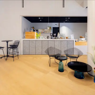 Furnished office lounge area at Solmsstrasse 83, Frankfurt Bockenheim, featuring casual seating around tables for office space rental.