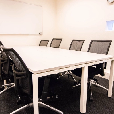 Office space rental at Kampenringweg 45, Gouda, featuring a meeting room with a large table, multiple chairs, and a whiteboard, perfect for collaborative sessions.